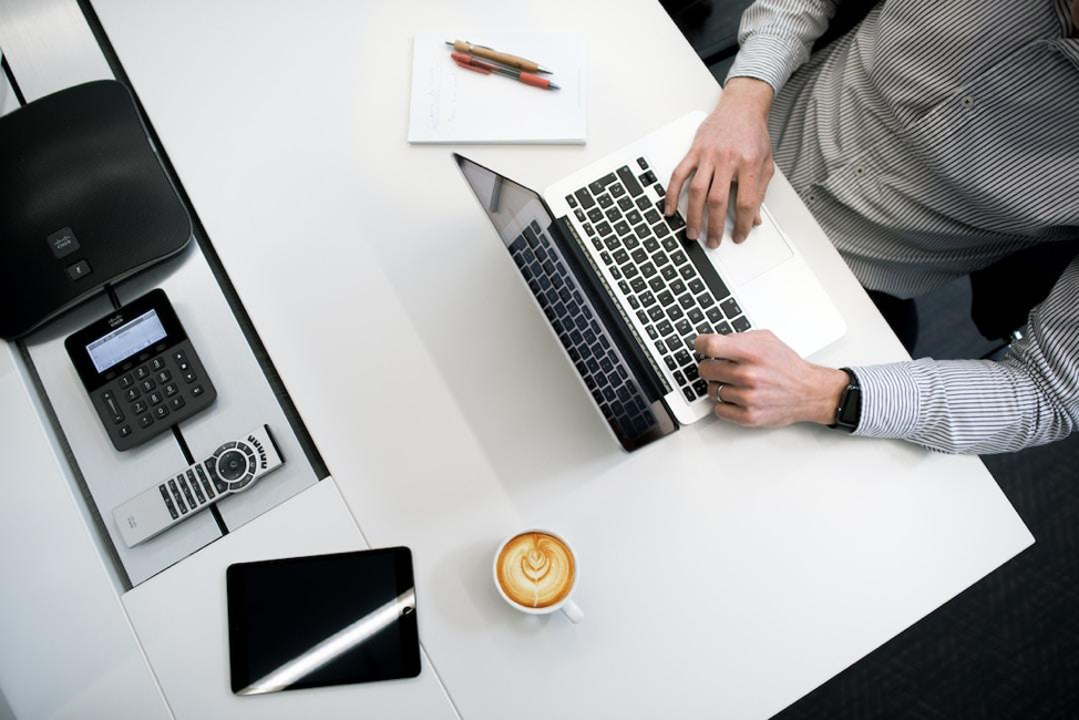 A business professional customizes a business proposal on a laptop